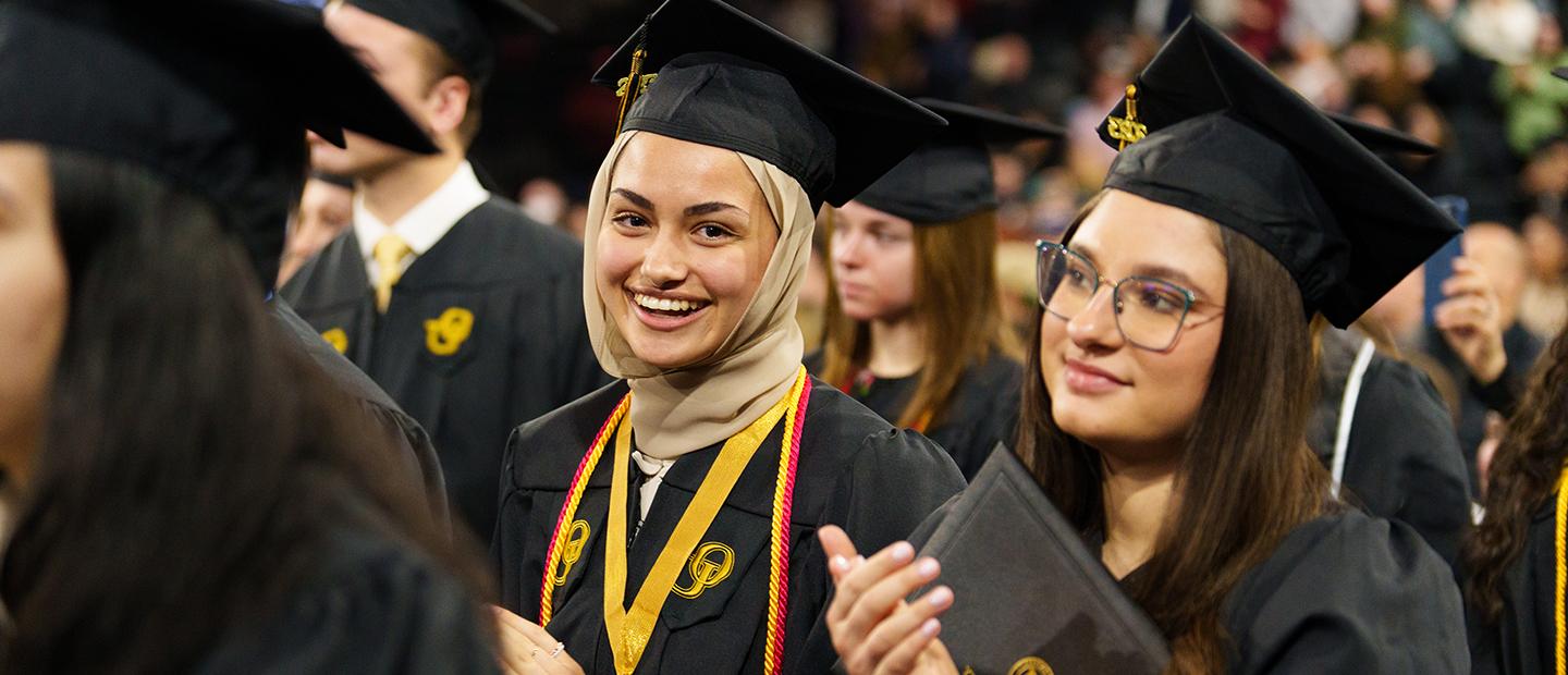 Two Oakland University graduates at Commencement